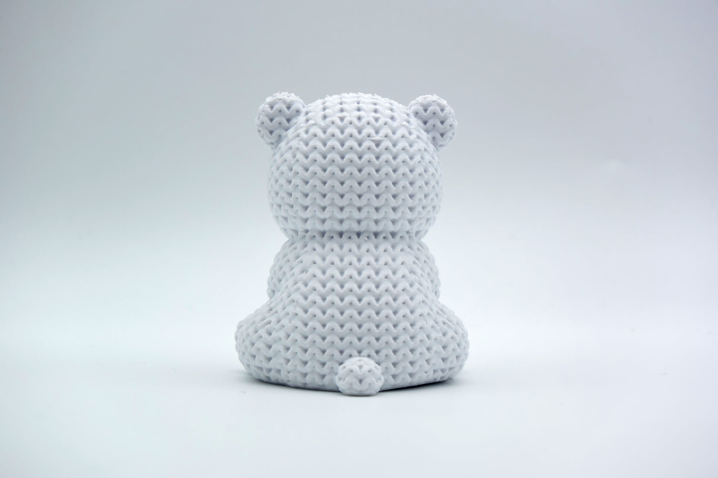 Texture detail of the knitted polar bear surface showing the interlocking weave pattern across the bear's back