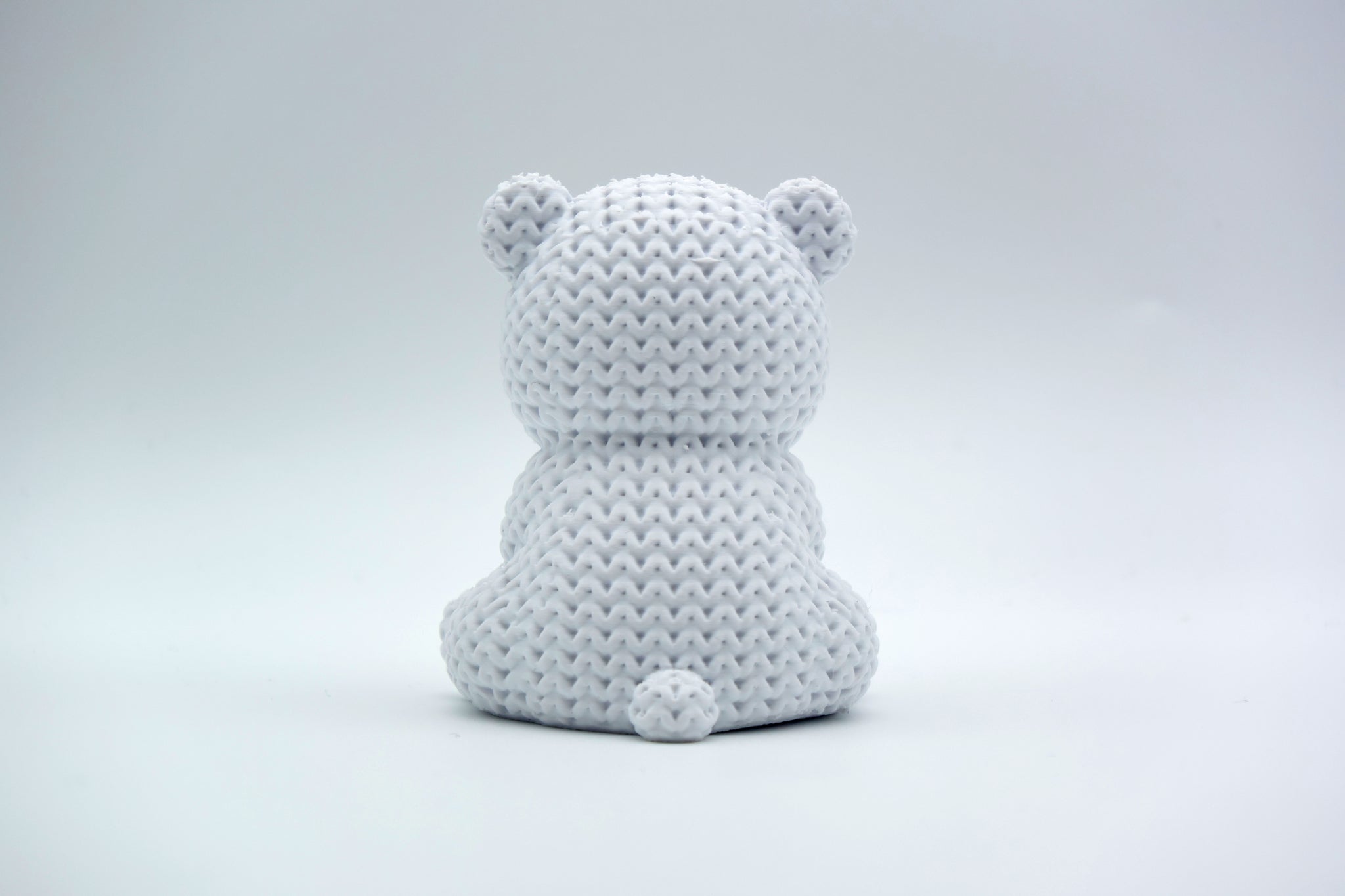 Texture detail of the knitted polar bear surface showing the interlocking weave pattern across the bear's back