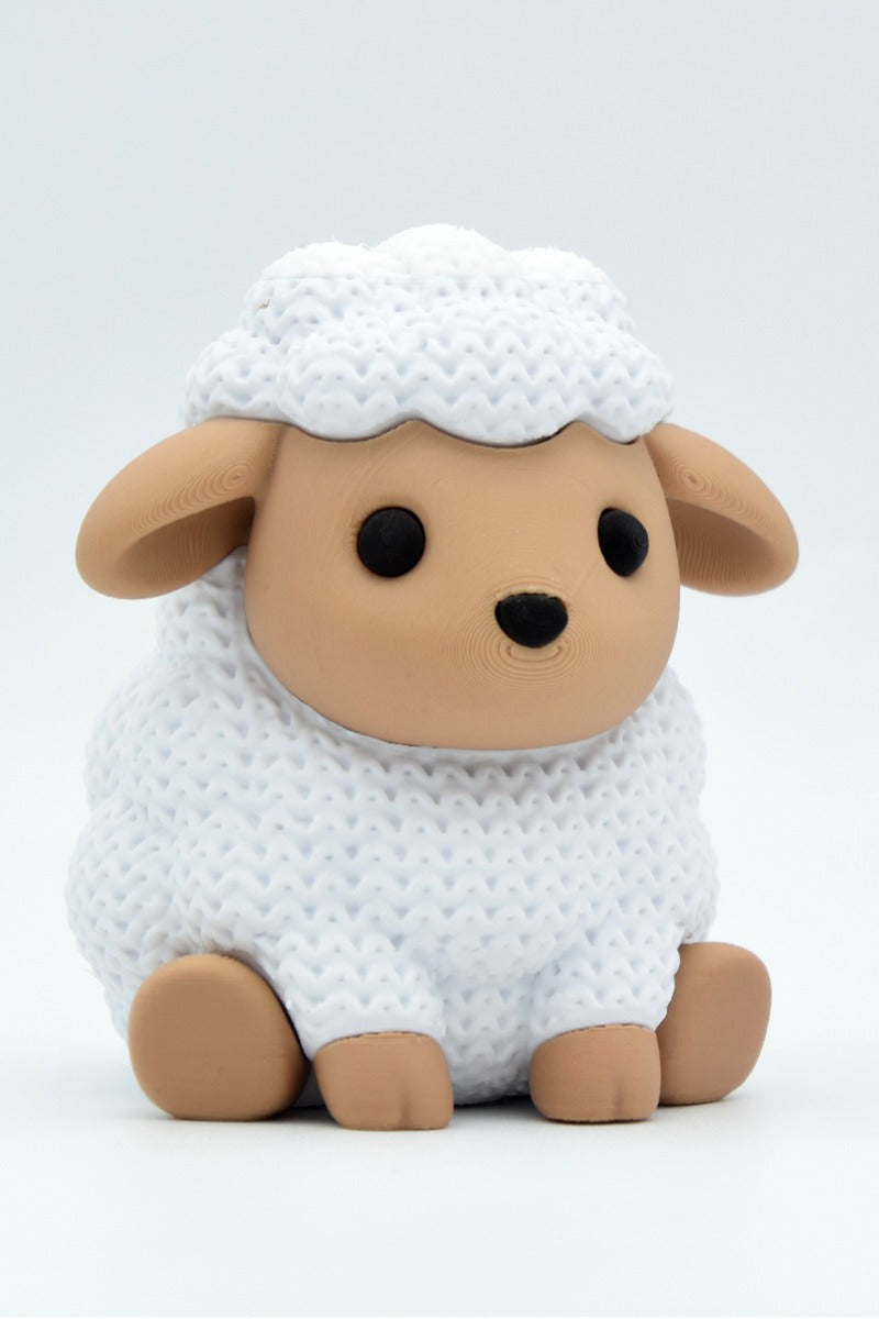 Close-up of a knitted sheep decoration with a soft crochet-look texture, small white woolly figure
