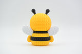 Detailed view of the crochet-look surface texture on a decorative bee figure showing stripe pattern and woven appearance