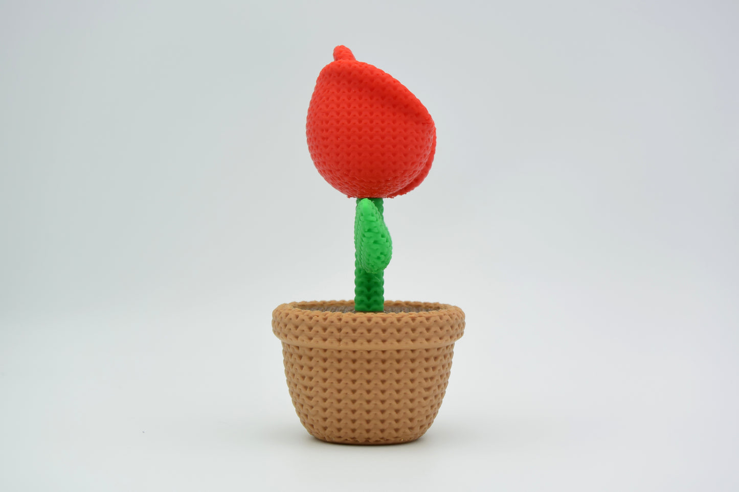 Detail shot of the knitted rose surface showing the layered textile-like texture of each petal