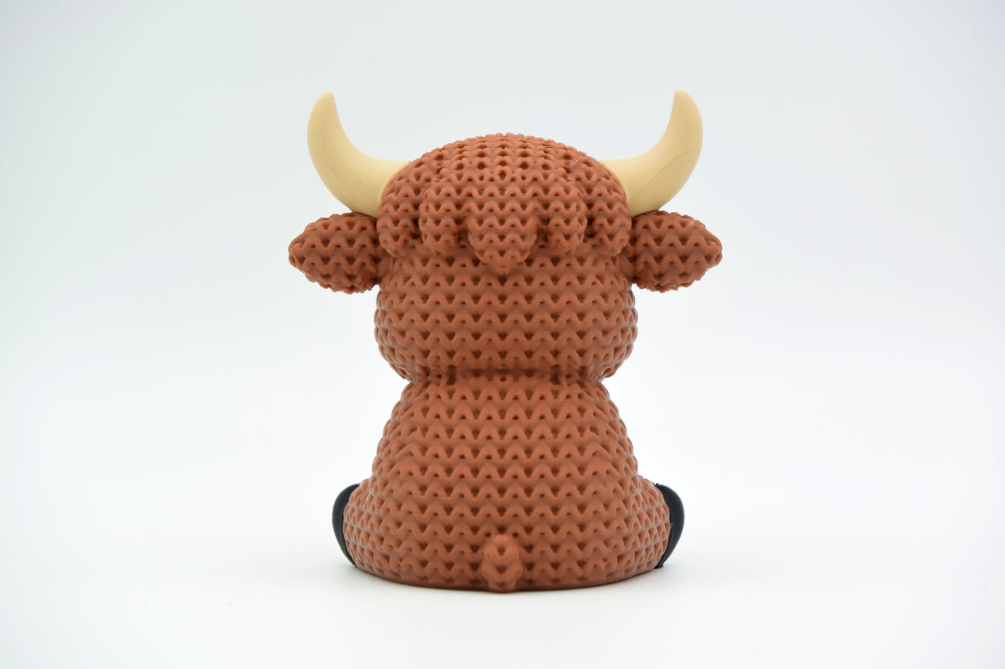 Detail shot of the crochet-look texture on a highland cow figure, showing the layered, yarn-like surface pattern