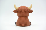 Detail shot of the crochet-look texture on a highland cow figure, showing the layered, yarn-like surface pattern