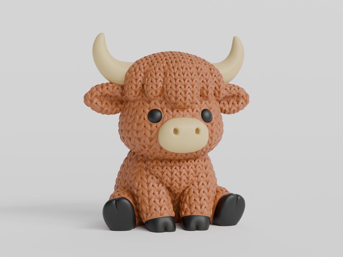 Close-up of a knitted highland cow figurine with a textured crochet-look coat and small sculpted horns