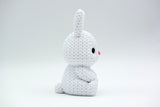 Close-up of a small knitted bunny decoration with soft crochet texture, white background, 49 DKK
