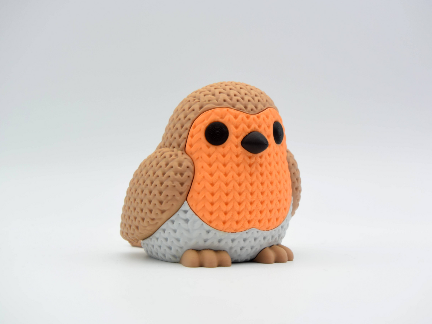 Close-up of a knitted robin bird figure with textured crochet-look surface and warm red breast, 49 DKK