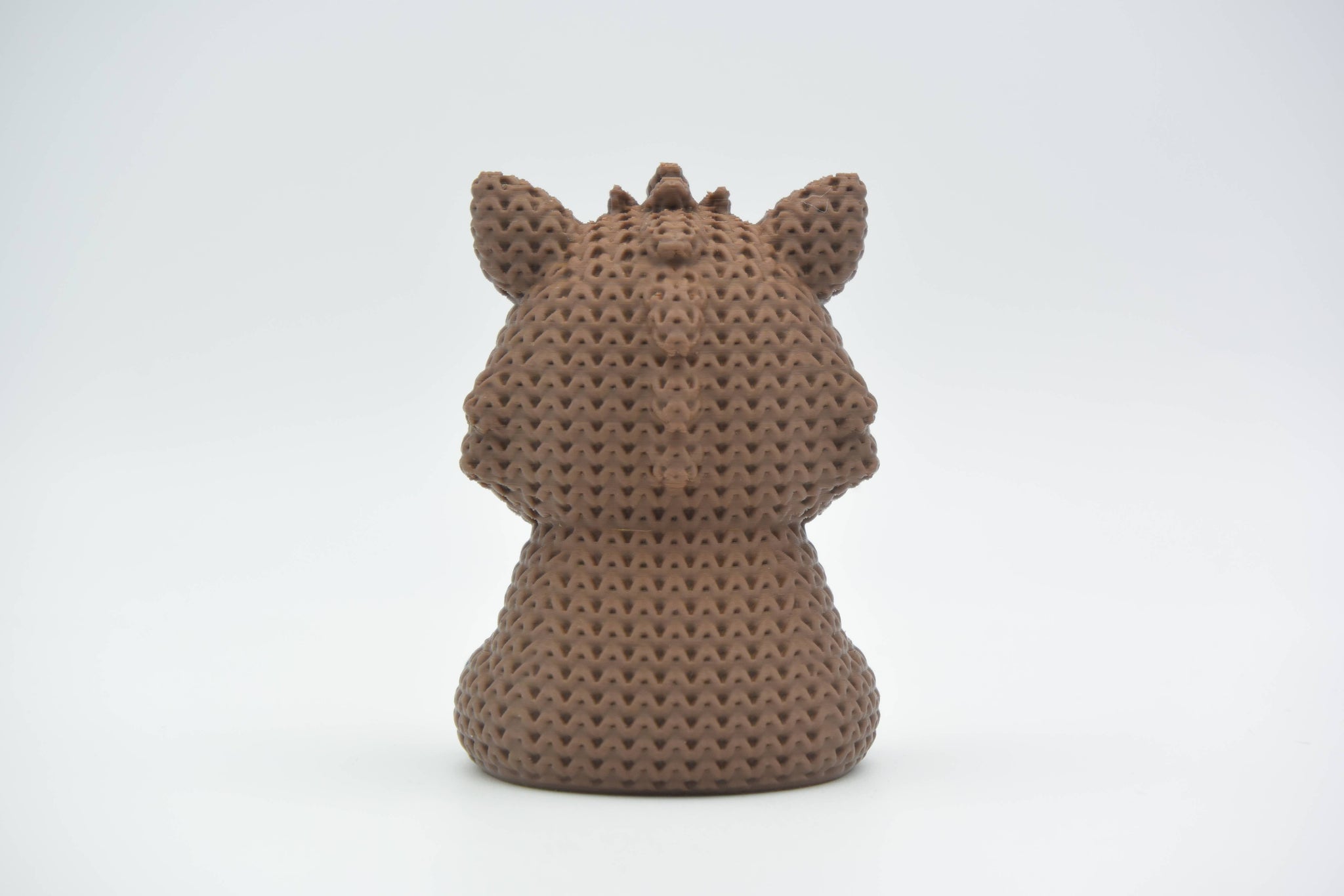 Detail shot of the looped crochet-look surface texture on a solid wild boar figurine