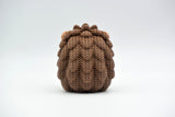 Macro detail of the crochet-look spine texture on a decorative knitted hedgehog figurine