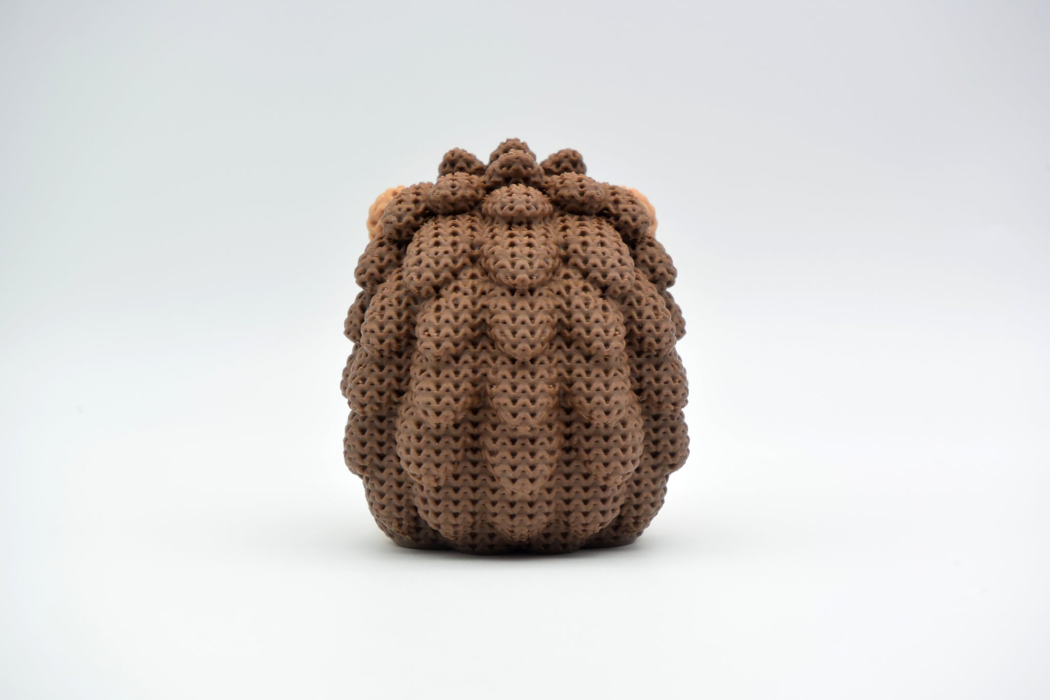 Macro detail of the crochet-look spine texture on a decorative knitted hedgehog figurine