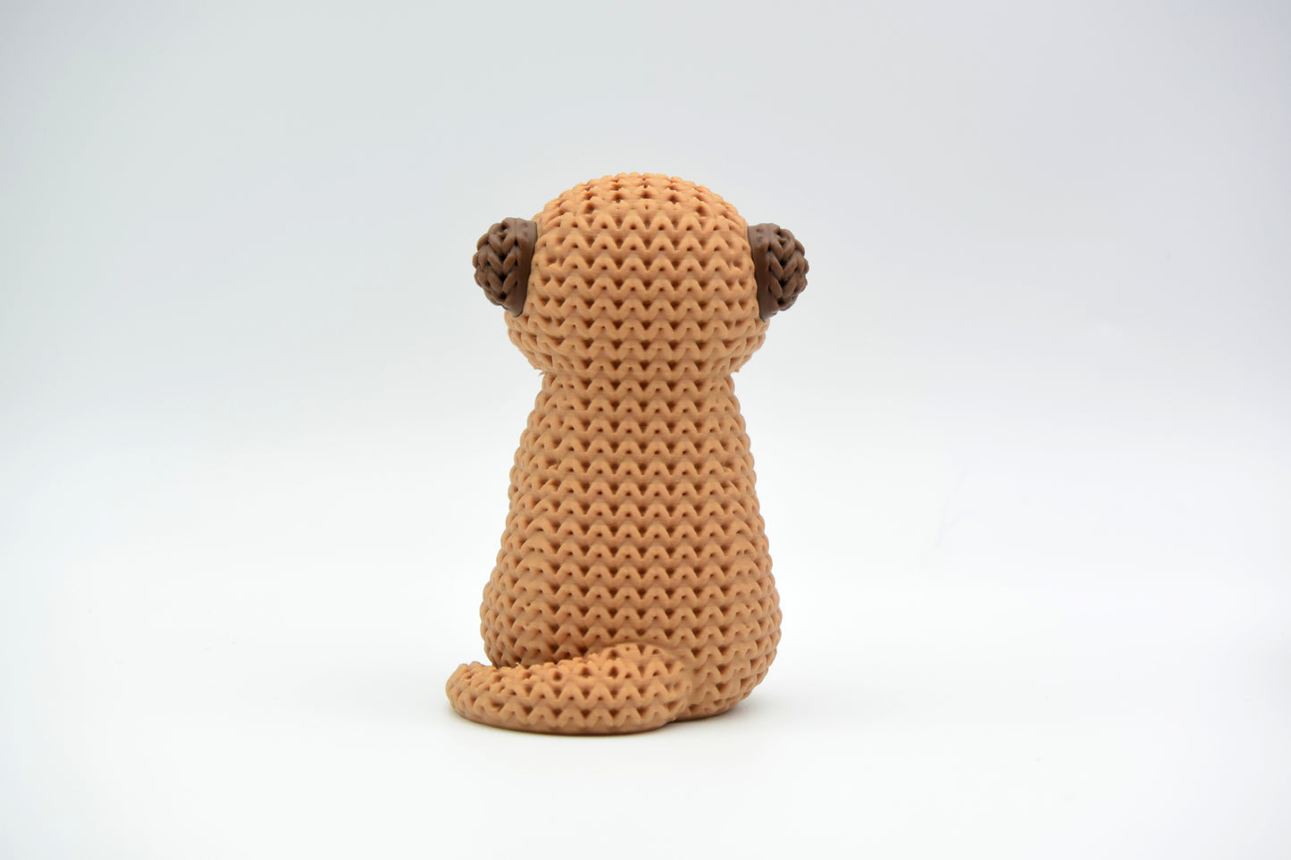 Detail of the crochet-look woven texture on the surface of a decorative meerkat figurine
