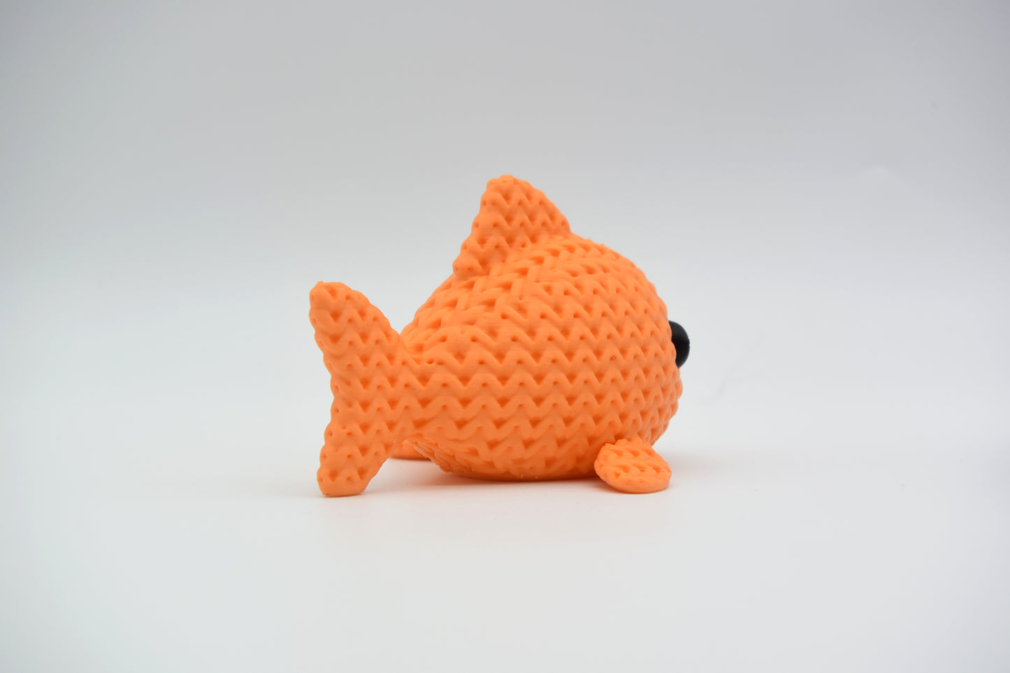 Detail of the crochet-look surface texture on a decorative knitted fish figurine