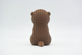 Texture detail of the knitted otter showing the woven loop pattern that gives the surface its handcrafted crochet look