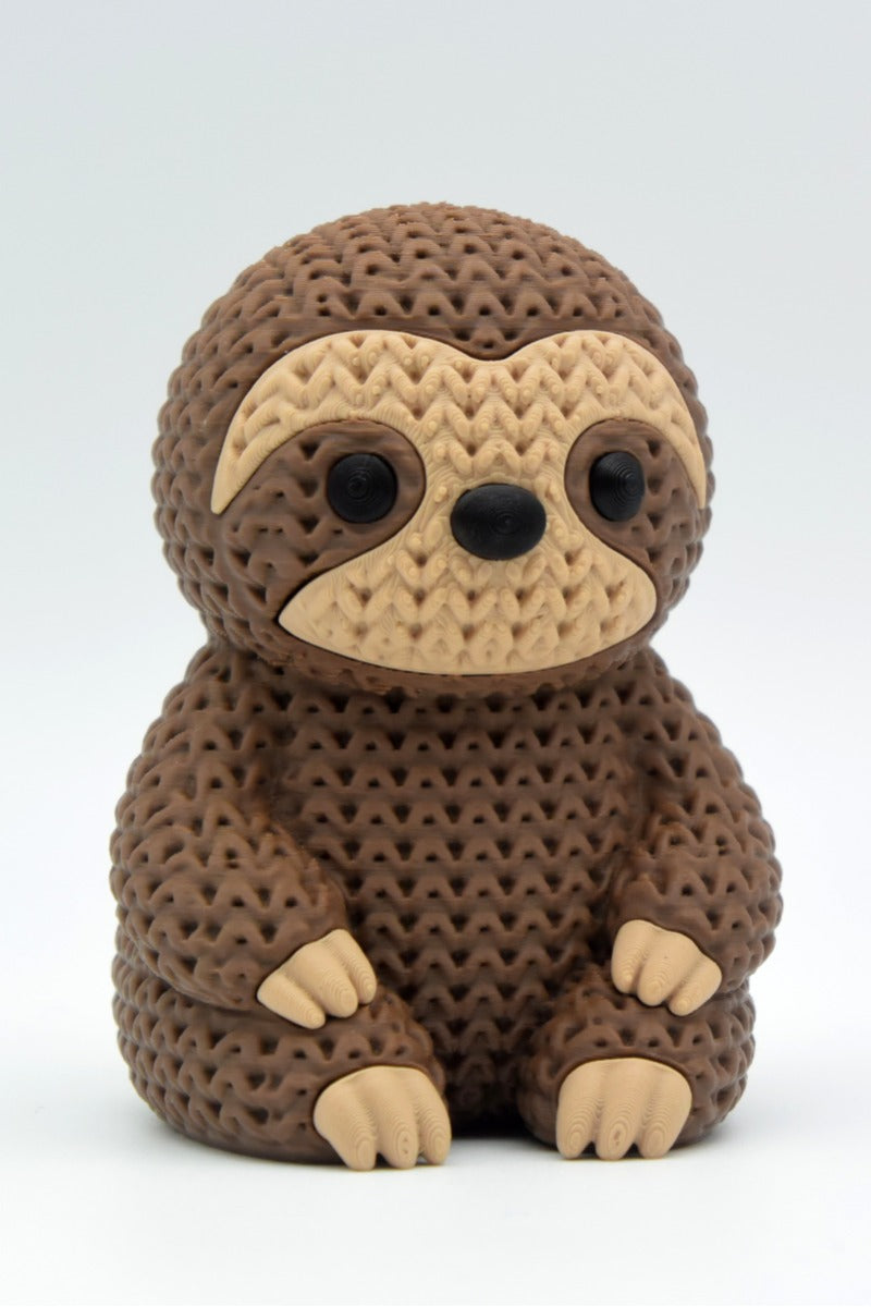 Close-up of a knitted sloth figurine with a soft crochet-look texture in warm tones, approx. 10 cm