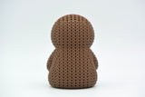 Detail shot of the crochet-look surface texture on a knitted sloth figure, showing stitched pattern relief