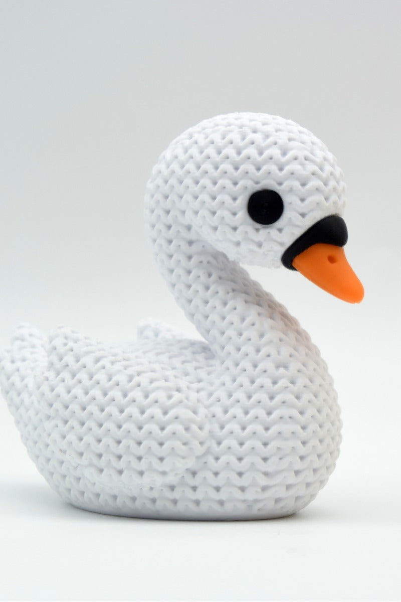 Close-up of a knitted swan decoration showing soft crochet-look texture across the wings and body
