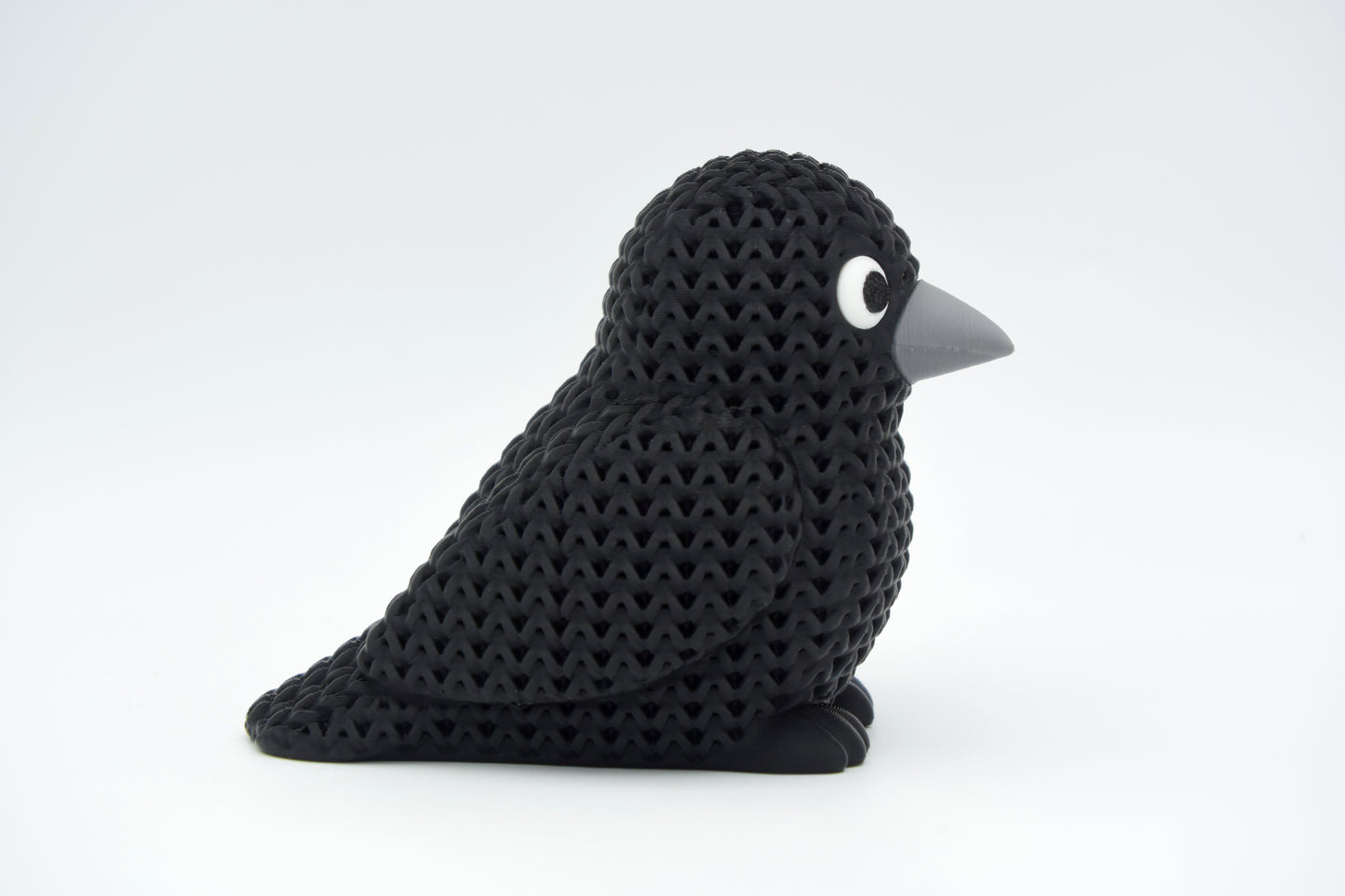 Decorative knitted crow placed on a wooden shelf in a calm Scandinavian living room setting