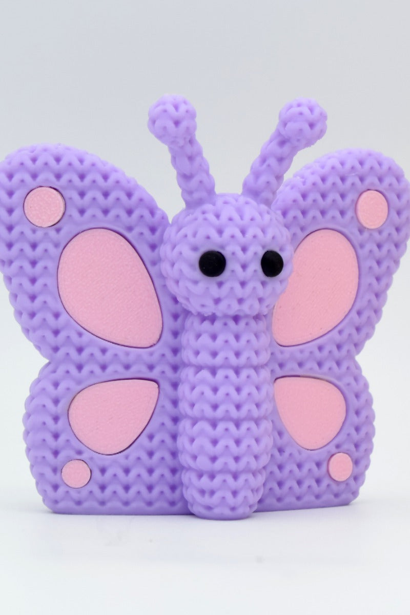 Close-up of a knitted butterfly decoration with crochet-texture wings in warm tones, 49 DKK