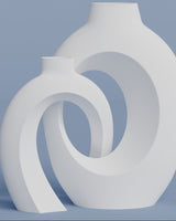 Close-up of a hollow nordic vase with an open crochet-like woven texture, shown in warm white